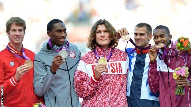 Robbie Grabarz (second from right) celebrates with other medal-winning athletes