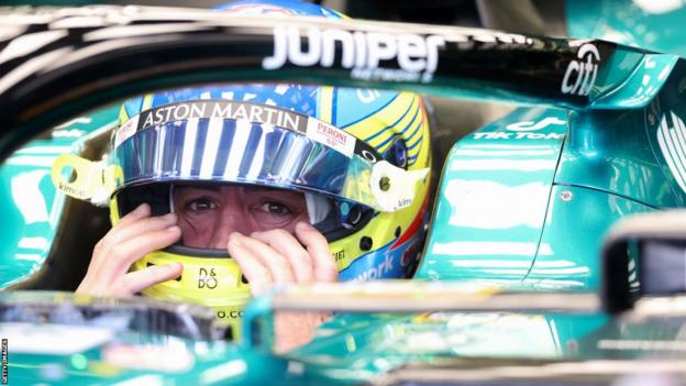 Fernando Alonso sits in Aston Martin cockpit