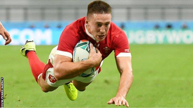 Josh Adams dives over for Wales' third try
