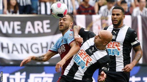 Newcastle midfielder Jonjo Shelvey battles for possession against West Ham in Shanghai