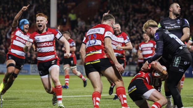 Gloucester players celebrate Seb Atkinson's try on the field