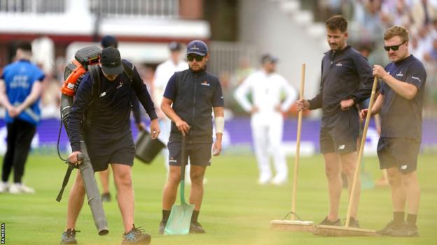 Lord's groundstaff clean up the orange powder