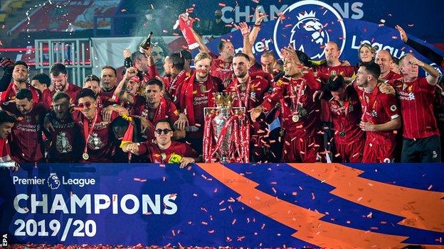 Liverpool's players celebrate as they lift the Premier League trophy