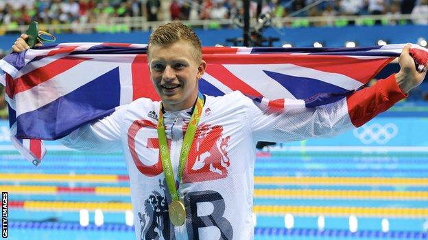 Adam Peaty holds the GB flag aloft after winning Olympic gold in Rio