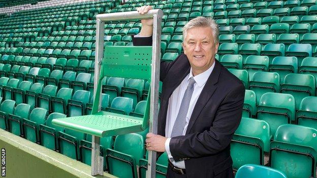 Celtic chief executive Peter Lawwell shows off the rail seat technology