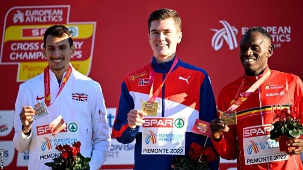 Britain's Emile Cairess, Norwegian Jakob Ingebrigtsen and Belgian Isaac Kimeli celebrate on the podium