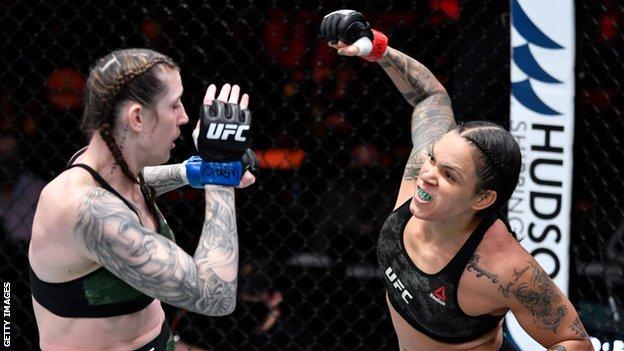 Amanda Nunes of Brazil (right) punches Megan Anderson of Australia in their UFC featherweight championship fight during the UFC 259 event in Las Vegas