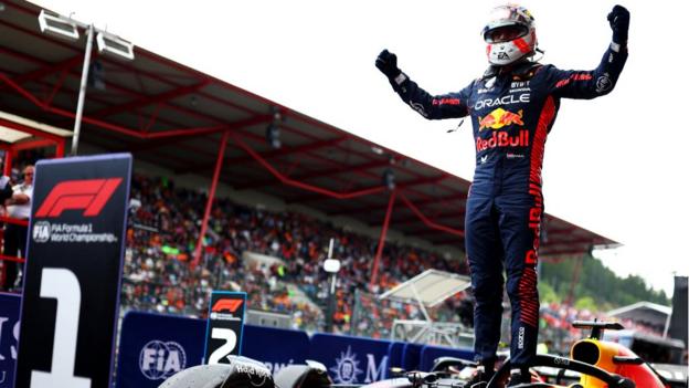 Max Verstappen stands on his car as he celebrates his Belgian GP win