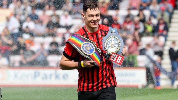 Chris Billam-Smith with his belts at an AFC Bournemouth match