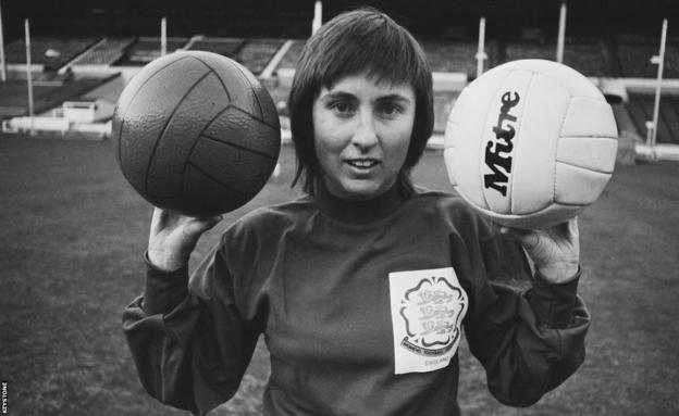 Sue Buckett, England goalkeeper, poses with two footballs, one plastic and one leather, at Wembley