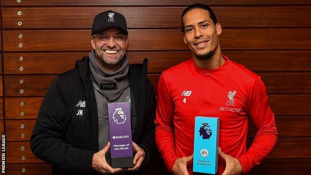 Liverpool manager Jurgen Klopp and defender Virgil van Dijk hold their trophies