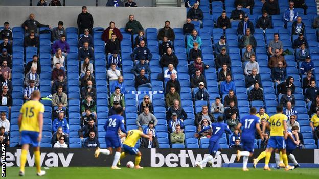 Socially distanced fans watch a pre-season friendly between Brighton and Chelsea