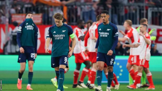 Arsenal players look dejected while Bayern Munich celebrate
