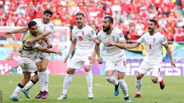 Iran players celebrate against Wales