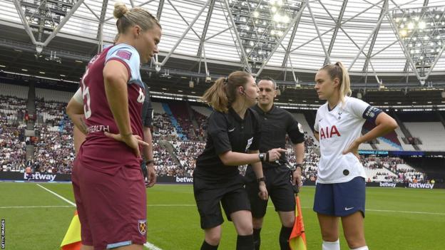 Gilly Flaherty (L) of West Ham United watches the coin toss with her opposite number Josie Green (R) of Tottenham Hotspur prior to the Barclays FA Women's Super League match at London Stadium