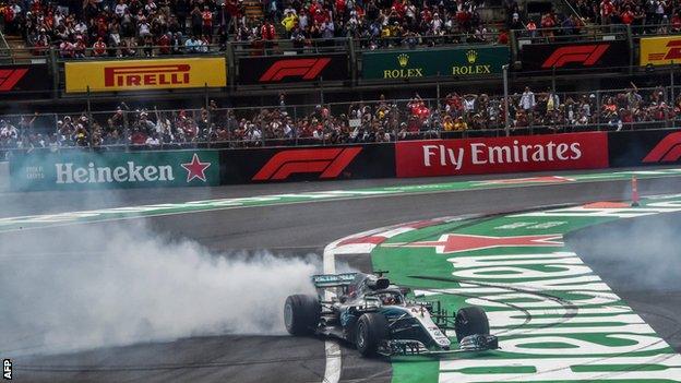 Lewis Hamilton celebrates clinching his fifth world title by performing a series of 'donuts' on the Hermanos Rodriguez circuit