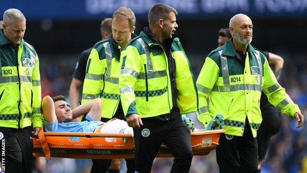 Manchester City player Aymeric Laporte leaves the Etihad field on a stretcher after suffering an injury in the game against Brighton