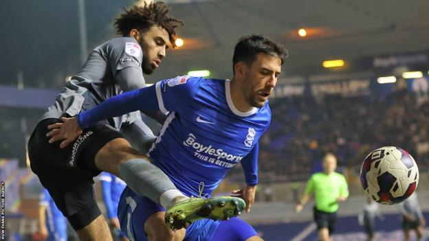 Kion Etete of Cardiff and Maxime Colin of Birmingham City tussle for the ball