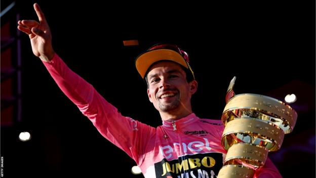 Primoz Roglic holds the Giro d'Italia trophy on the podium