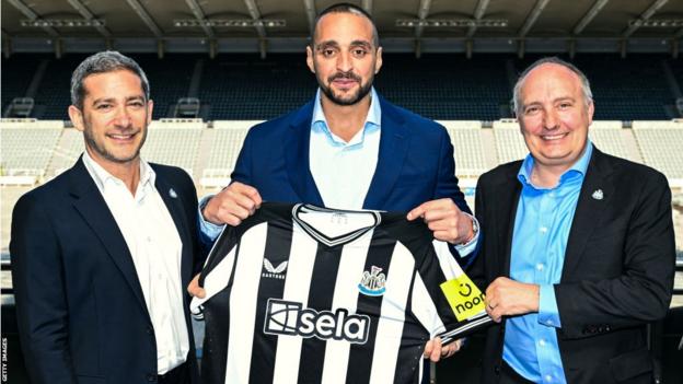 Newcastle display their new home shirt and sponsor