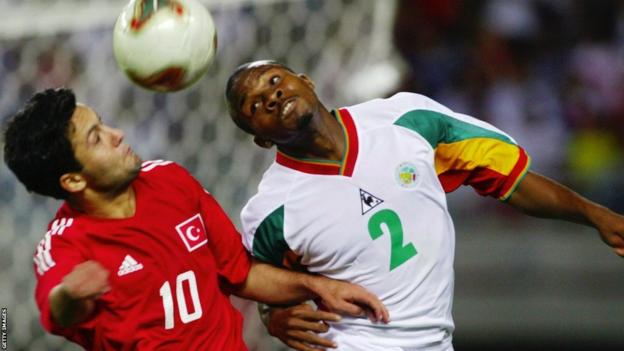 Yildiray Basturk and Omar Daf challenge for the ball at the 2002 World Cup