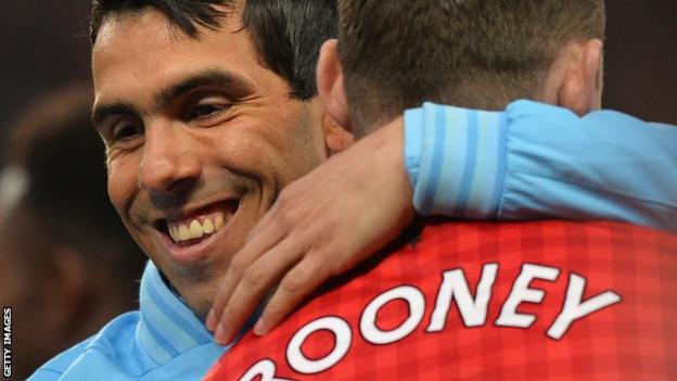 Manchester City's Carlos Tevez pictured with Manchester United's Wayne Rooney in 2013
