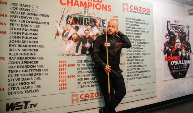 Luca Brecel poses next to a list of previous World Championship winners