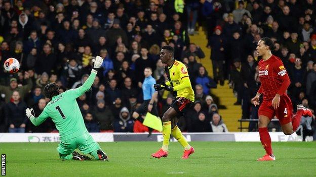 Watford's Ismaila Sarr chips over Liverpool's Alisson