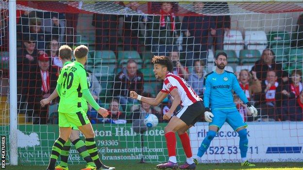 Marcus Kelly's own goal puts Lincoln ahead against Forest Green