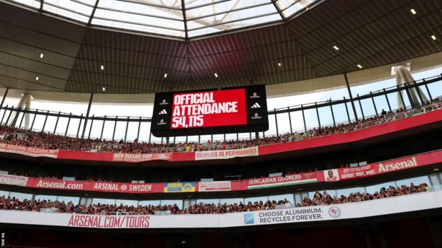 A board shows the record attendance of 54,115 at the Emirates Stadium