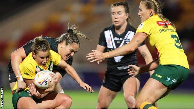 Samantha Bremner of Australia is tackled by Mya Hill-Moana of New Zealand