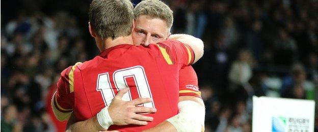 Dan Biggar and Rhys Priestland hug after Wales' 28-25 win over England in the 2015 World Cup