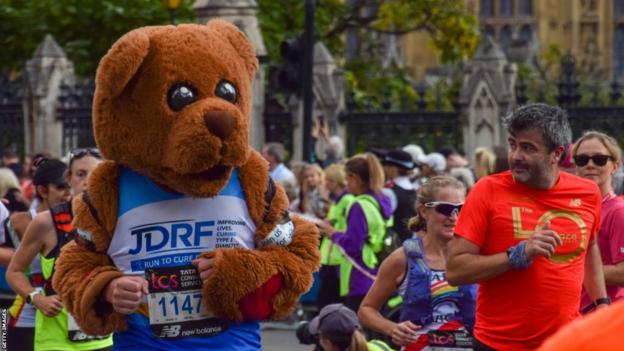 A runner dressed as a teddy bear passes through Parliament Square