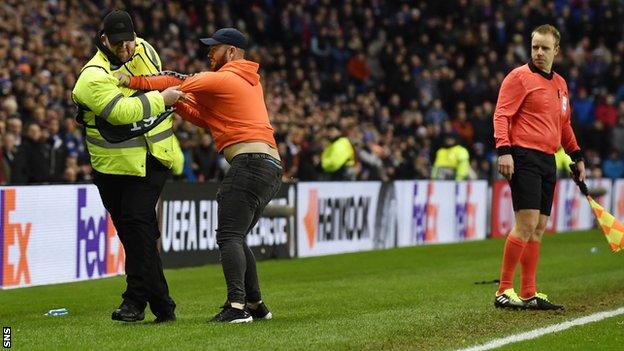 A fan grapples with a steward during Rangers' draw with Villarreal