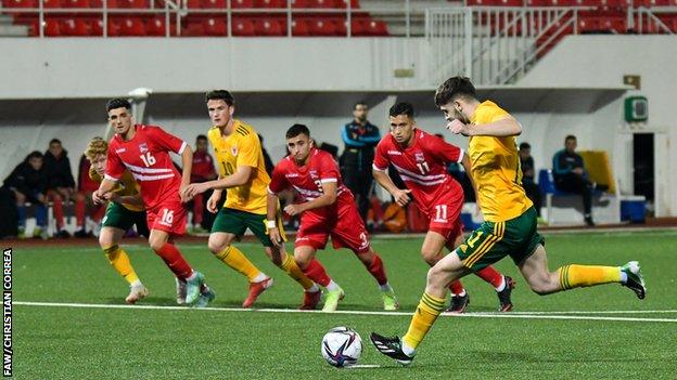 Joe Adams scores Wales' second goal from the penalty spot.