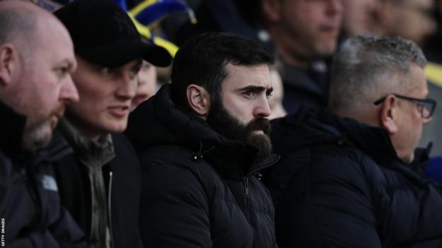 Jack Price watching Shrewsbury Town from the stands