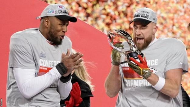 Travis Kelce with the AFC Championship Trophy in 2023