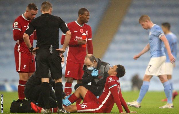 Trent Alexander-Arnold is treated after picking up an injury against Manchester City
