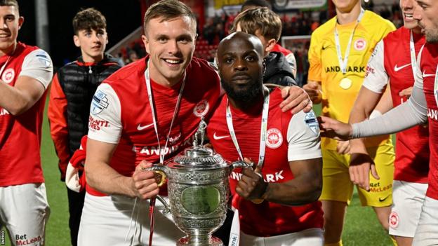 Graham Kelly and Fuad Sule celebrate with the Gibson Cup after Larne secure the Premiership title