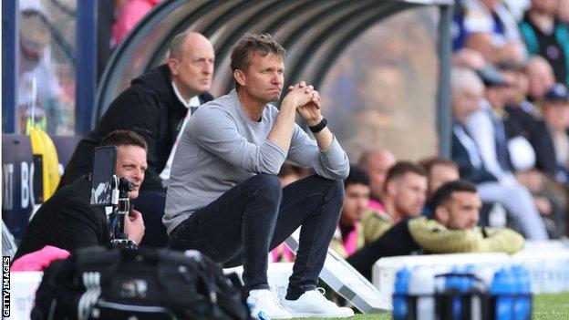 Jesse Marsch sat on the edge of the Leeds dugout