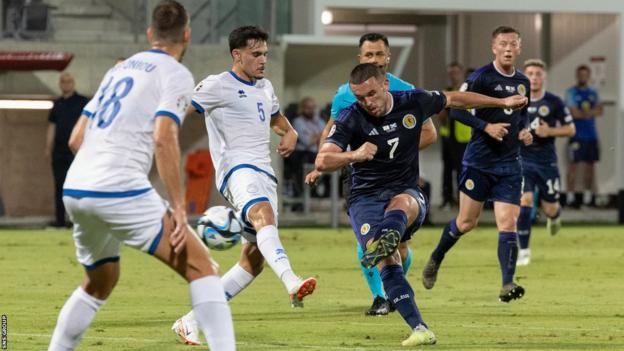 Scotland's John McGinn scores to make it 3-0 during a UEFA Euro 2024 qualifier between Cyprus and Scotland at the AEK Arena