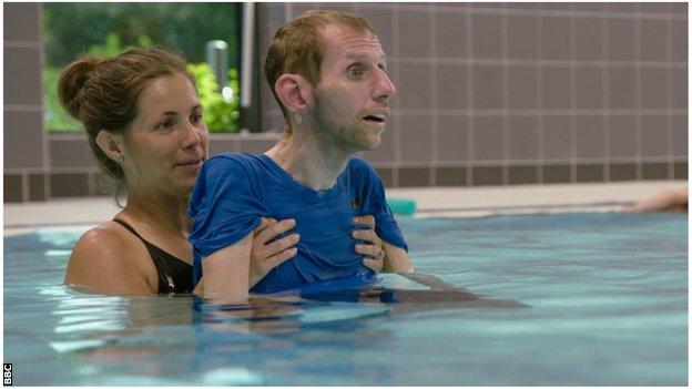 Rob's wife, Lindsey, helps him with physiotherapy in the swimming pool.