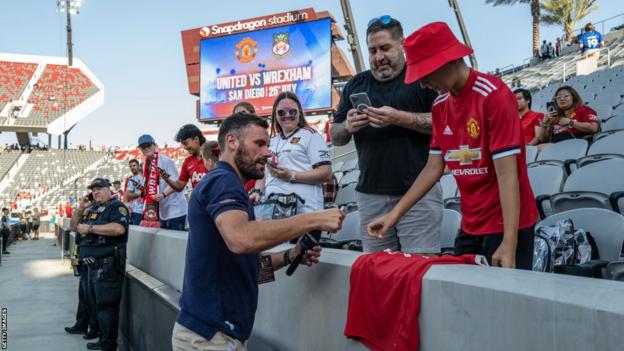 Wrexham goalkeeper Ben Foster, formerly of Manchester United, signs a fans' shirt