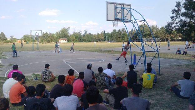 Refugees play tape-ball cricket in the Obrenovac camp