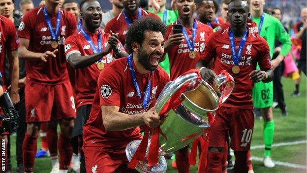 Mo Salah celebrates with the Champions League trophy