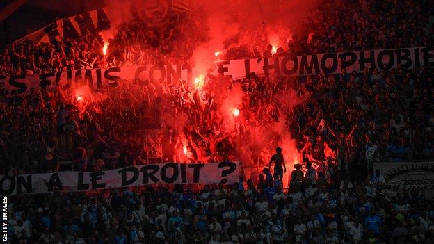 Marseille supporters hold up banners with messages against homophobia