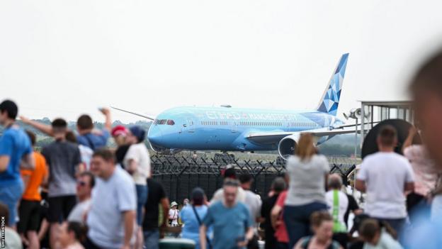 Fans gather as Manchester City's plane lands at Manchester Airport