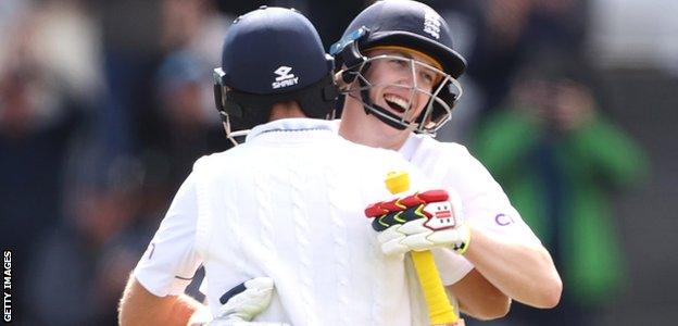 Joe Root and Harry Brook embrace