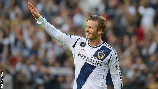 Former LA Galaxy midfielder David Beckham waves to fans after winning the 2012 MLS Cup in his final game for the club