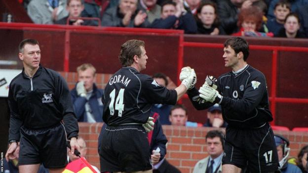 Manchester United goalkeepers Andy Goram and Raimond van der Gouw trade places during a game in the 2000-01 season